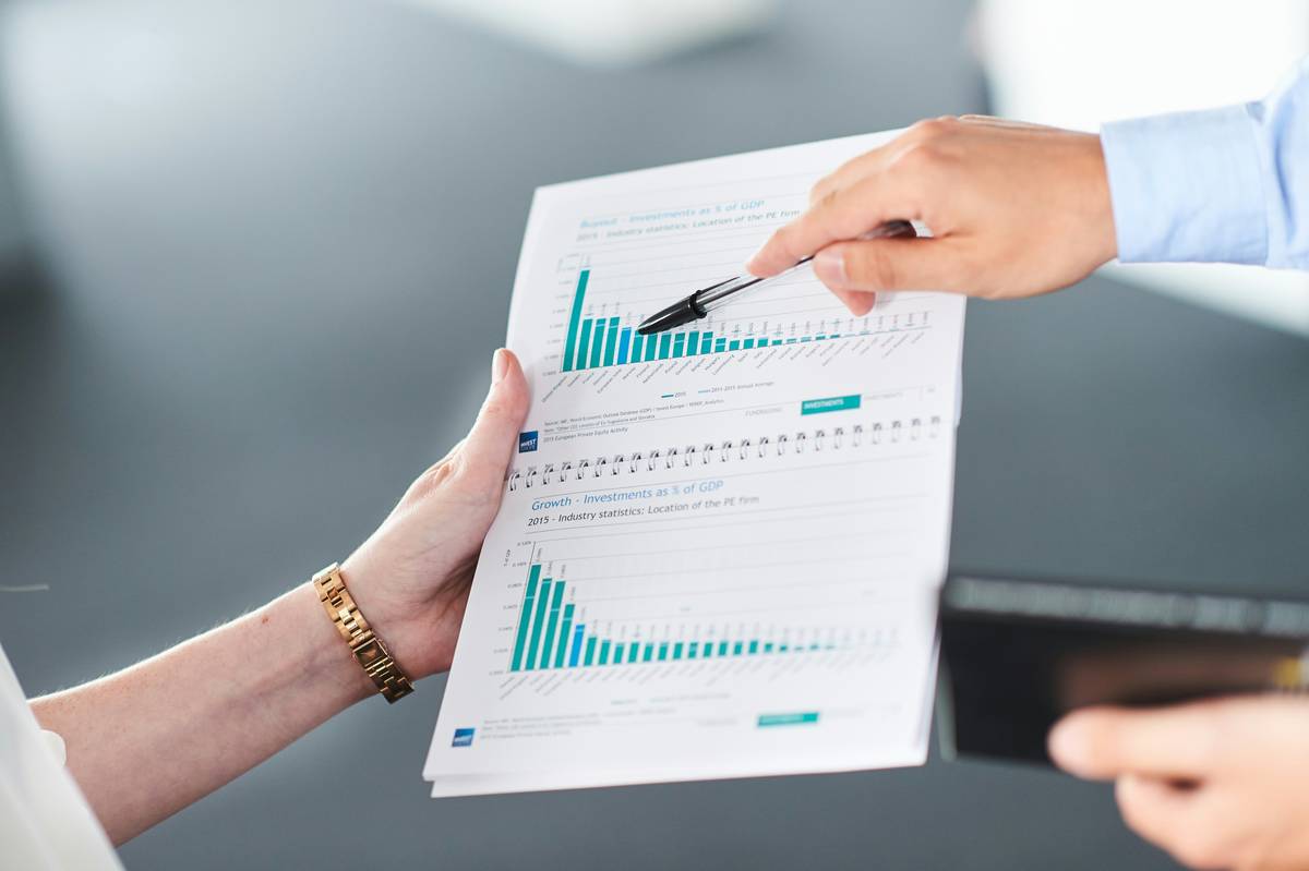 woman analyzing financial planning intelligence questionnaire to ask with notebook and calculator